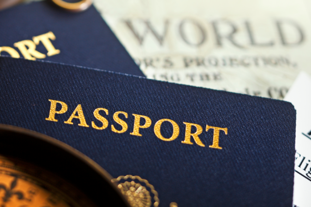 Flat-lay of blue passports, a travel itinerary, a compass, and a world map background, used in the blog Dubai Tourist Visa Requirements 2025 Don’t Fly Without Reading This Guide