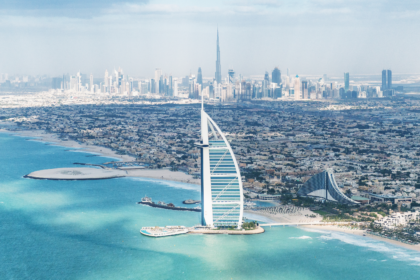 Aerial view of Dubai with the Burj Al Arab and city skyline, showing how you can experience luxury and sights even when exploring Dubai on a budget.