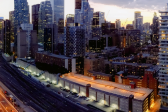 A panoramic dusk view of a modern city skyline with towering skyscrapers, bright city lights, highways, and train tracks — a visual symbol of the urban excitement and iconic landmarks you can experience on a well-planned Dubai 5 day itinerary, covering city tours, cultural spots, modern architecture, and vibrant nightlife.