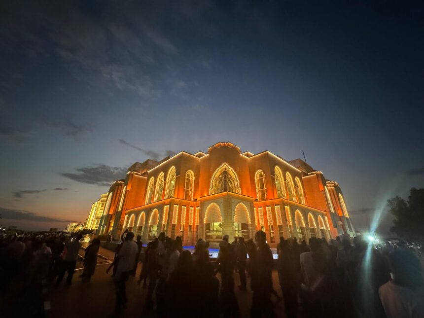 Crowds enjoying illuminated grand building at night during a trip to Dubai, showcasing the city’s vibrant cultural events and attractions.