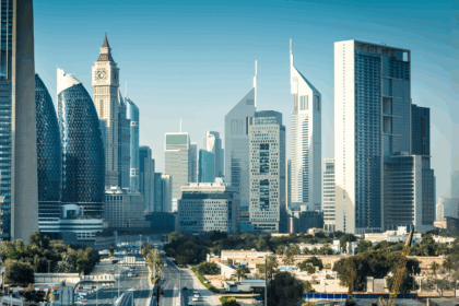 Daytime view of Dubai’s central business district featuring modern skyscrapers, including Emirates Towers and nearby high-rise architecture, with minimal traffic and clear skies—ideal conditions for off-season travel in Dubai.